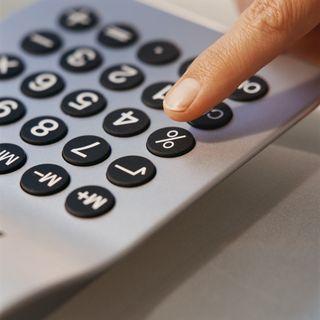 Person punching on a calculator