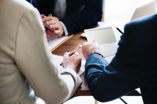 Two people at a conference table
