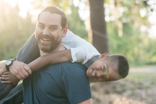 Dad throwing his son over his shoulder