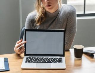 Woman pointing to a laptop screen
