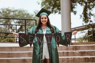 Graduate Holding Sign