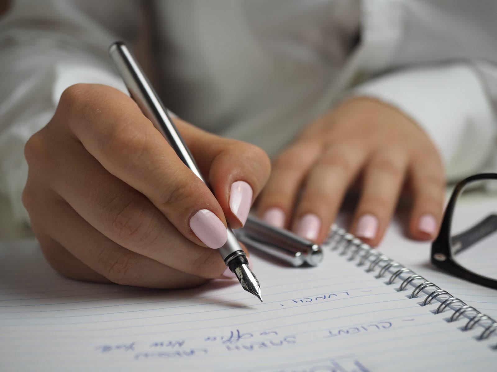 Woman Writing in Notebook