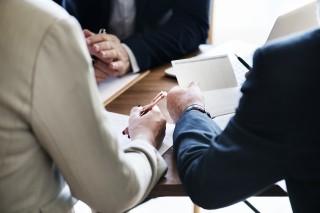 Two hands at a table