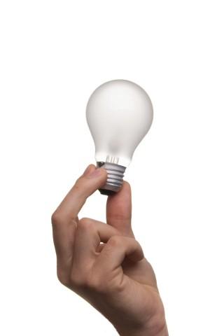 Hand holding a light bulb