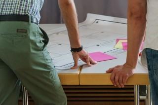 People reviewing paperwork on a desk
