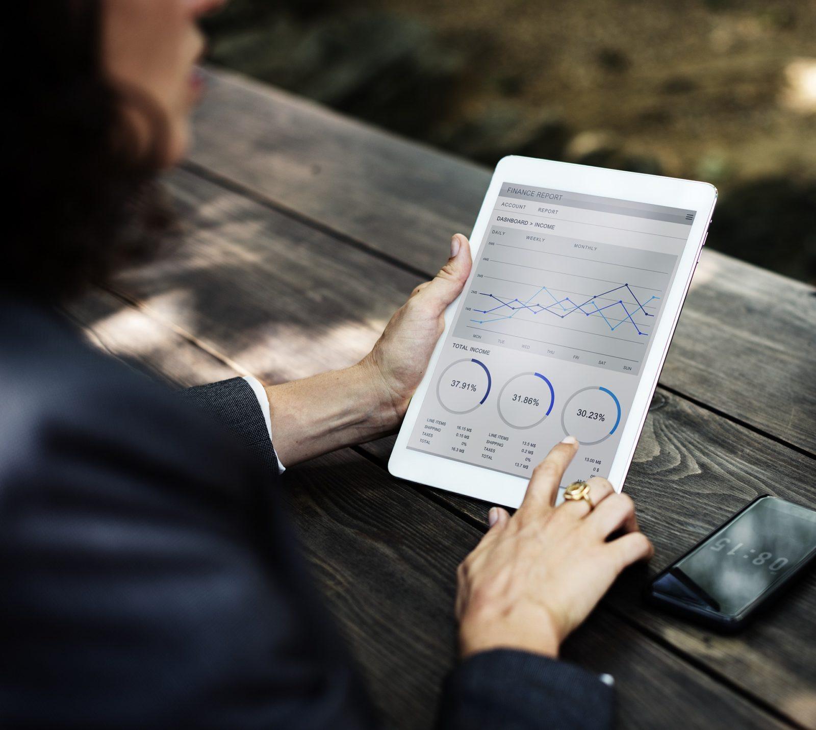 Woman Looking at Finance Report on Tablet
