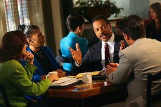 Group of people discussing over a meal