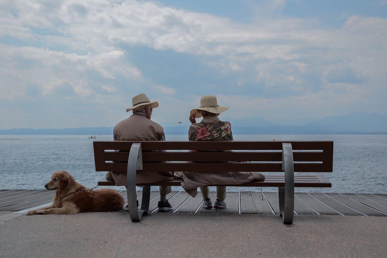 Elderly Couple with Dog by the Beach