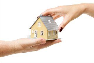 image of a house being held by two hands