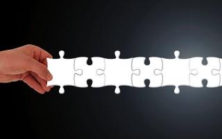 person putting puzzle pieces together