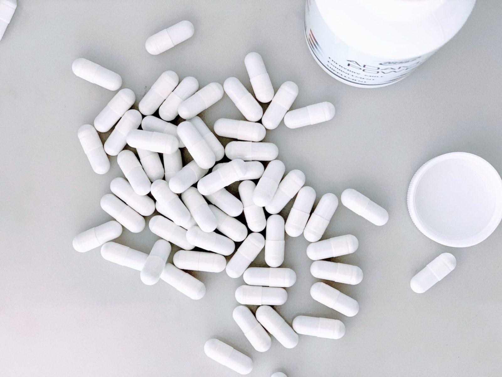 bottle of white pills spilt