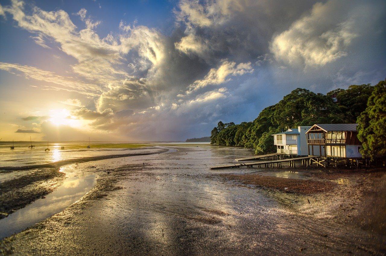 house on a beach at sunset
