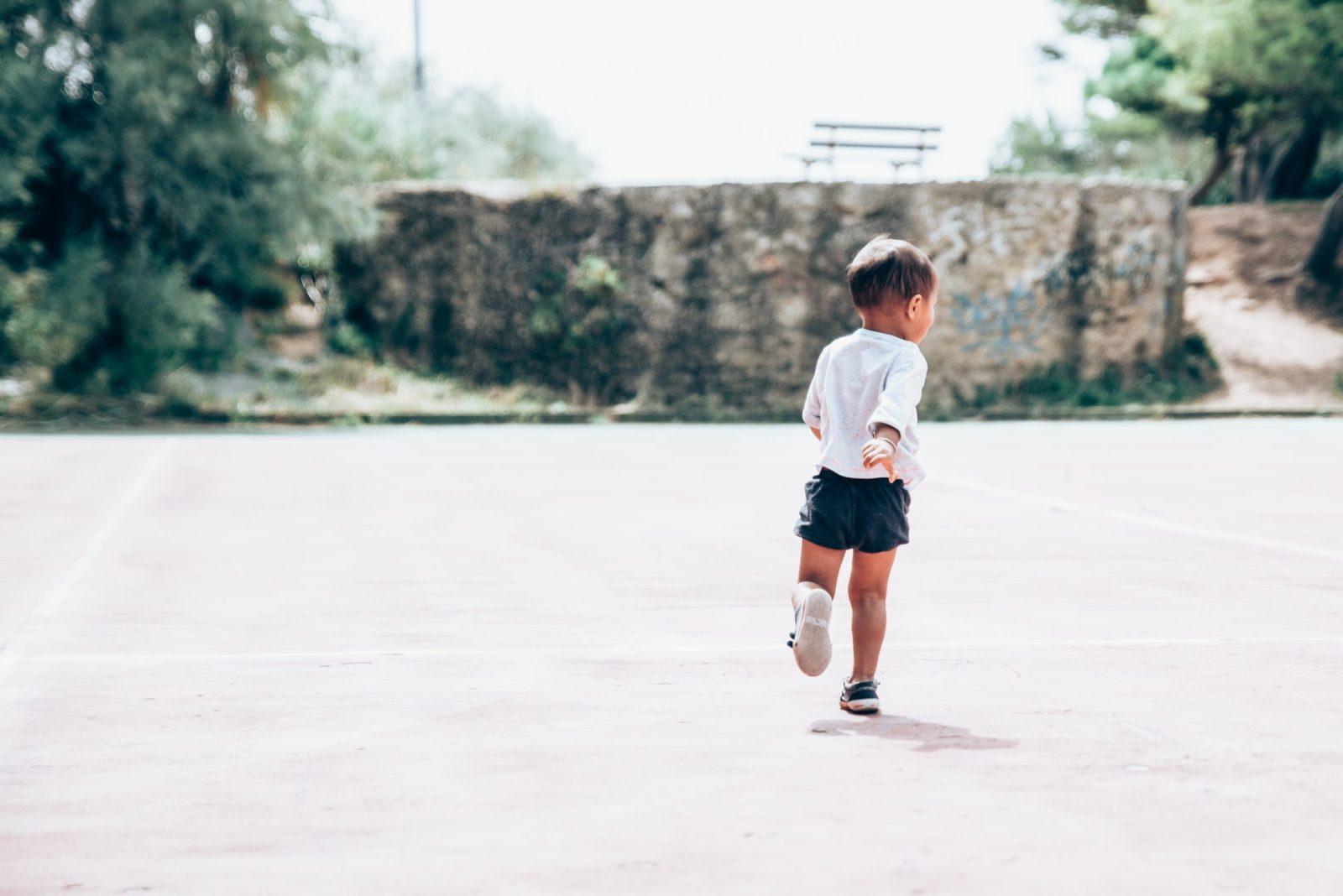 child running across pavement