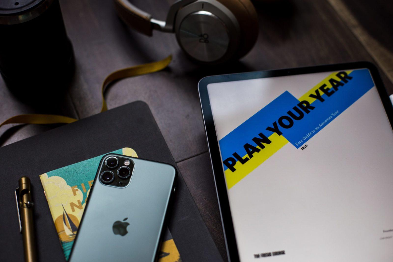 photo of a desk and tablet that says "Plan Your Year" on it
