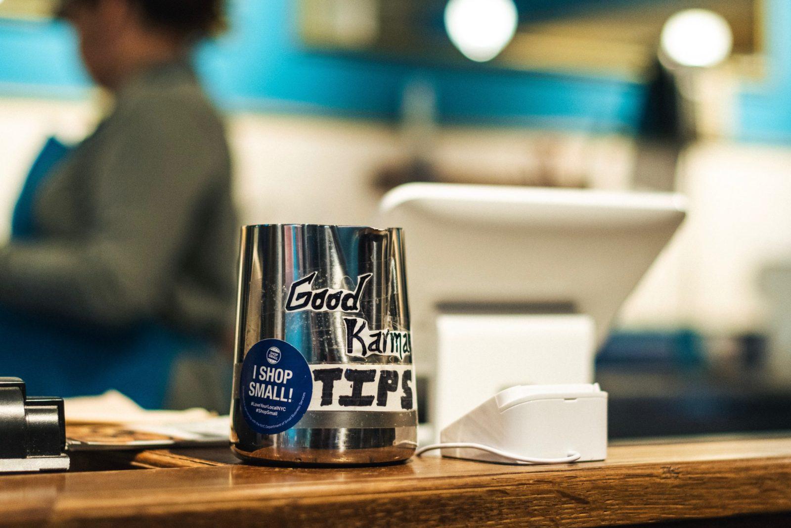 cash register with a tip can