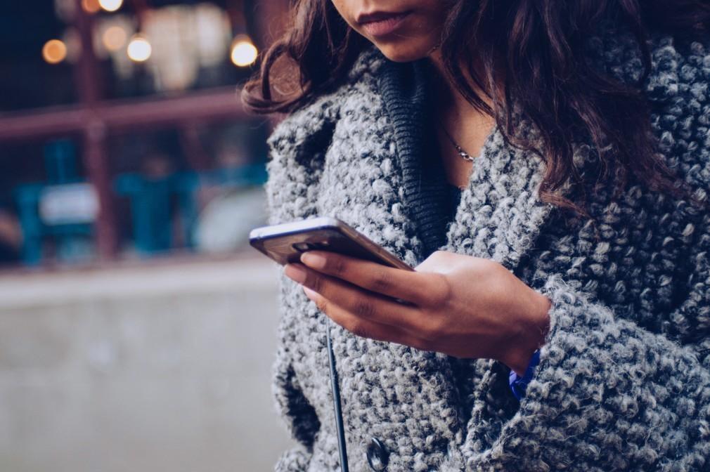 woman outside using her phone