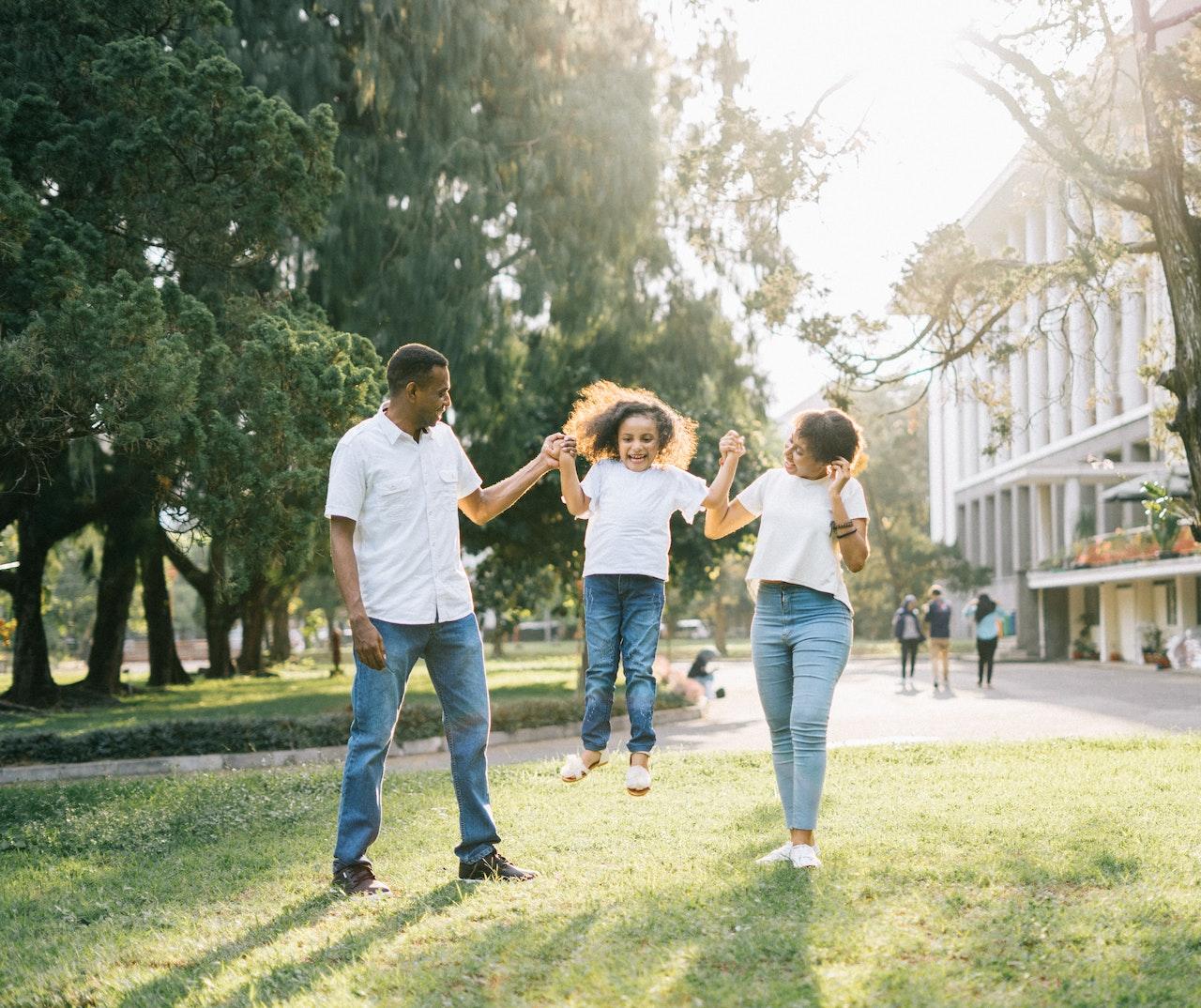 family running and jumping outside