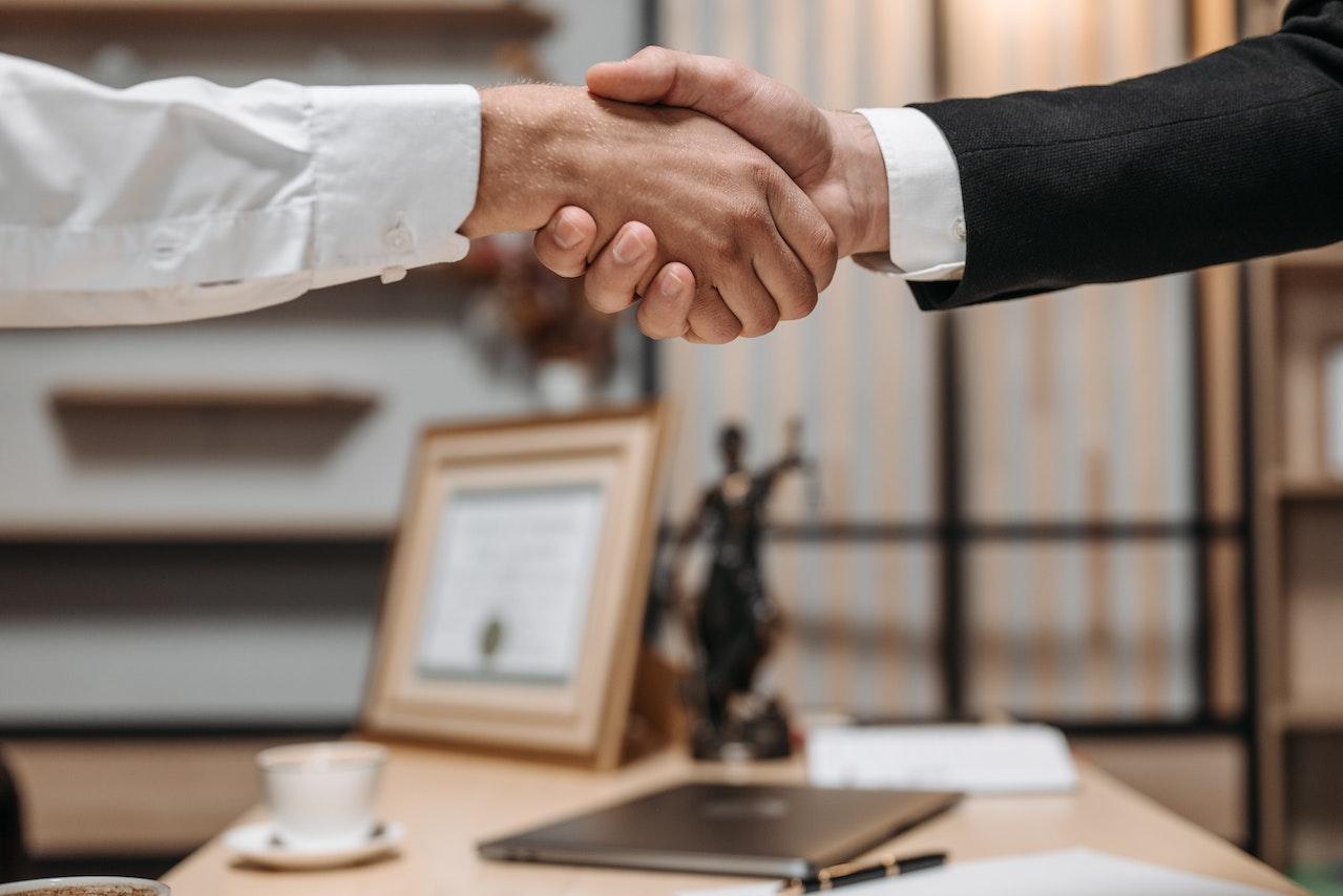 handshake over a desk