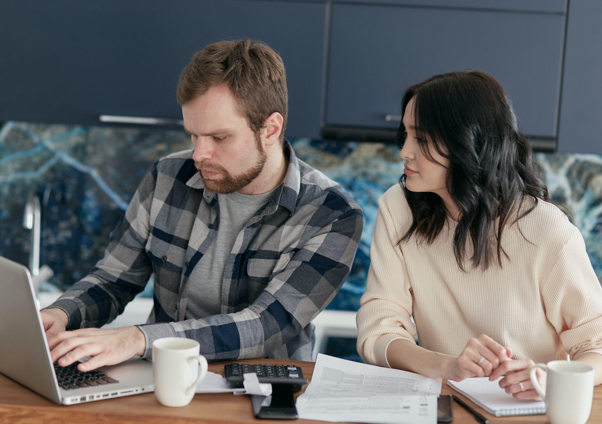 Couple looking at a laptop together