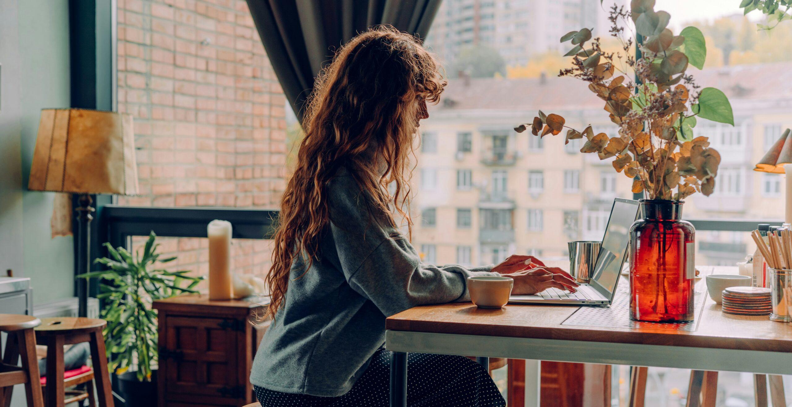 A woman typing on a laptop
